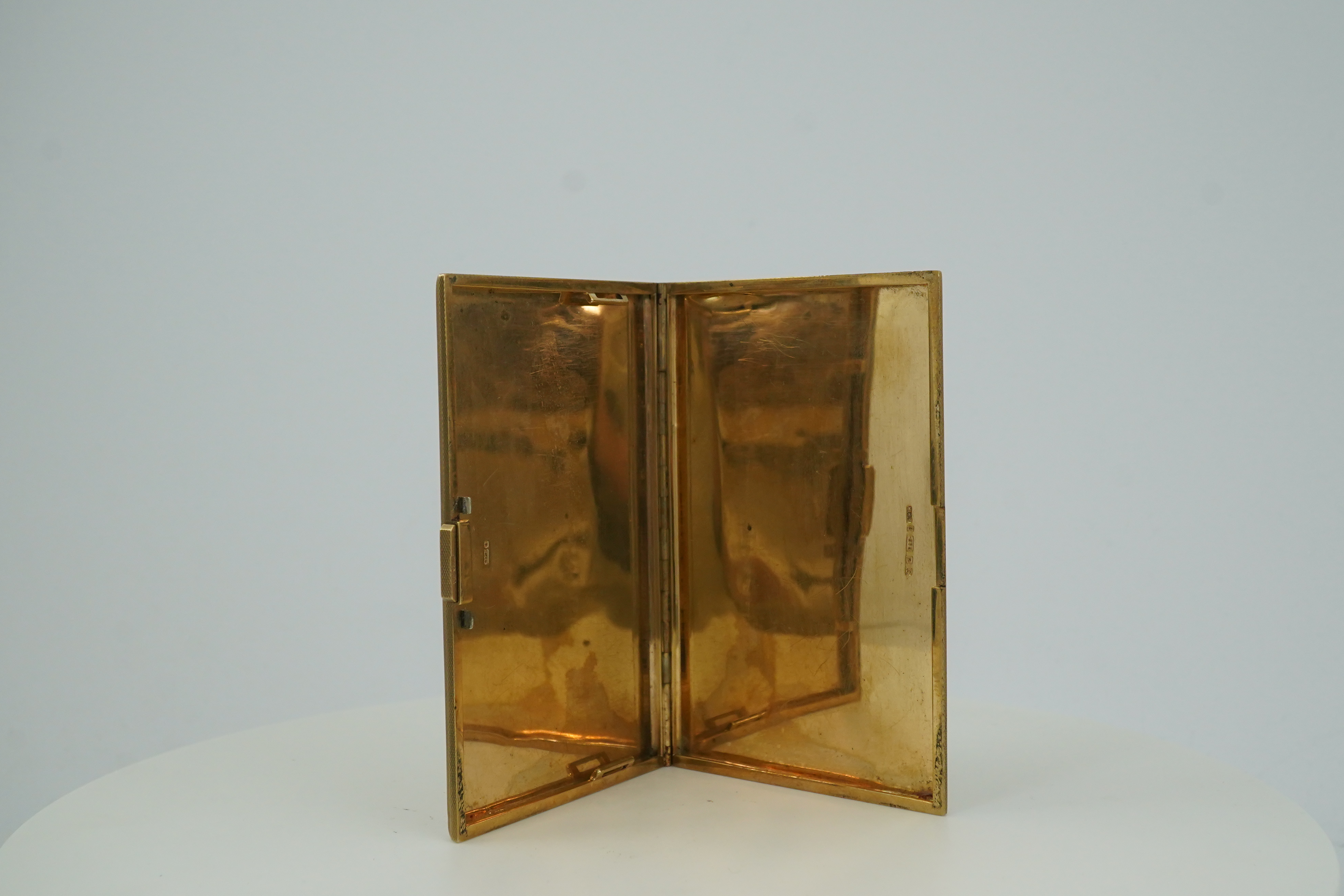 A 9ct gold rectangular cigarette case, circa 1947